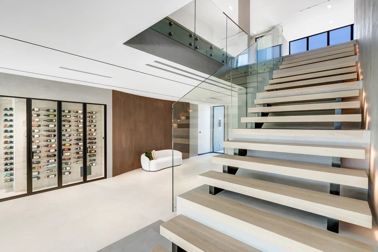 Staircase and glazed wine display at 493 Holiday Drive